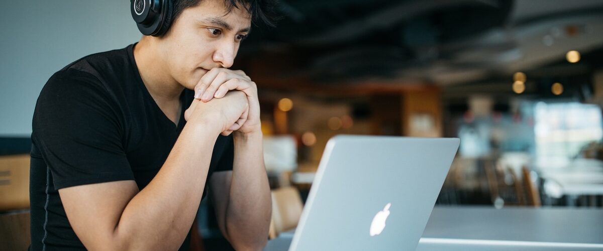 man looking at the laptop screen