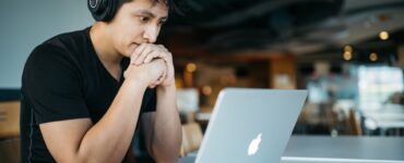 man looking at the laptop screen