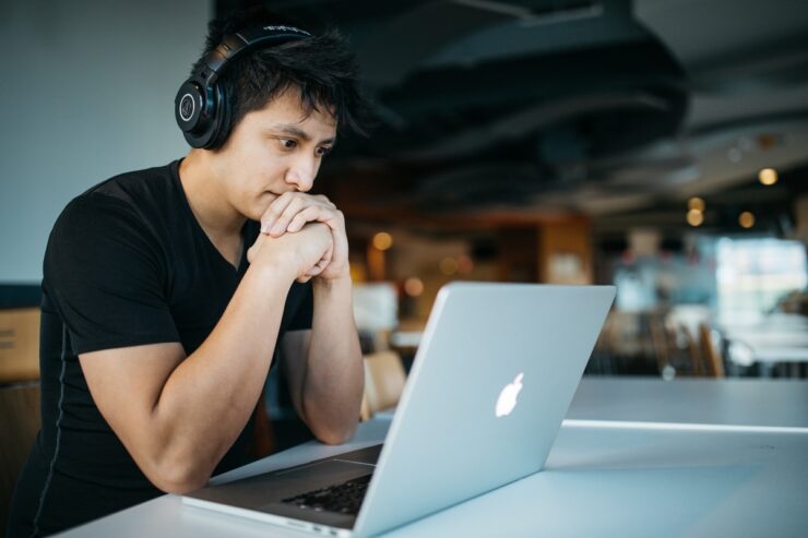 man looking at the laptop screen